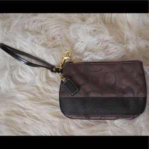 Brown and black Coach wristlet